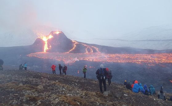 Хора по склоновете на вулкана Фаградалсфядъл, наблюдаващи изригването на Geldingadalir.