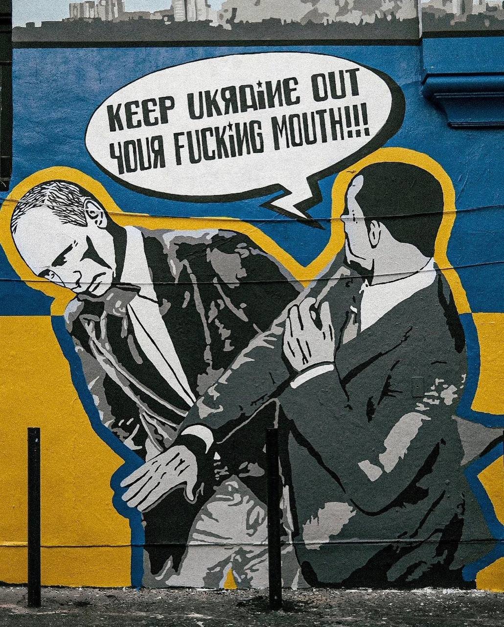 Графити изобразяващо сцена в която Уил Смит шамаросва руския президент