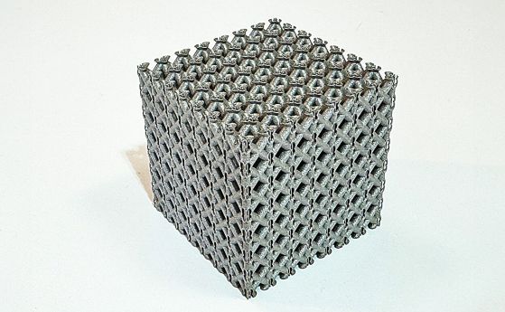 Образец на новата титаниева решетъчна структура, отпечатана на 3D принтер под формата на кубче. 