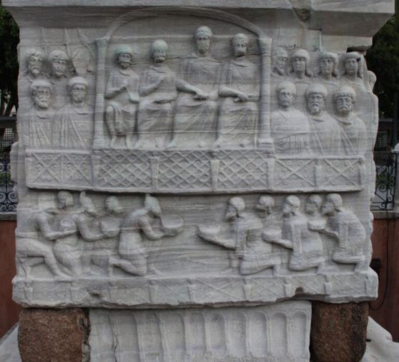 Основа на обелиска на Теодосий I в Хиподрума на Константинопол. Долнaтa лента изобразява брадати фигури, поднасящи дарове на Теодосий, докато горната вдясно изобразява дългокоси стражи от палатинските схоли - късноримски елитни гвардейски подразделения