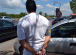 Арестуваният Михаил Маджов чака до колата си да го отведат. Снимка: МВР