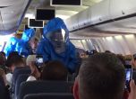 Медицински лица в предпазни костюми претърсват самолета.